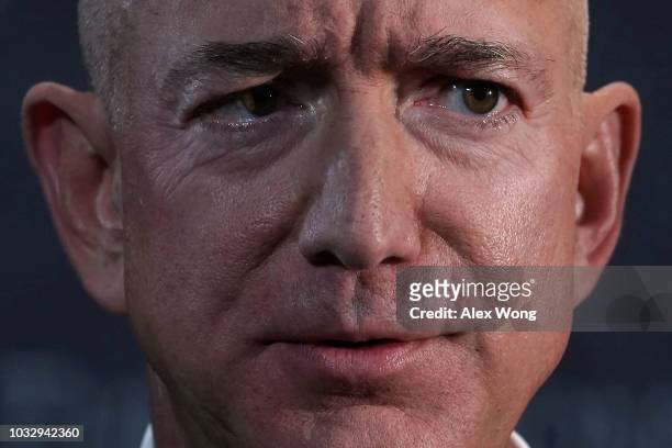 And founder of Amazon Jeff Bezos participates in a discussion during a Milestone Celebration dinner September 13, 2018 in Washington, DC. Economic...