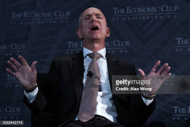 And founder of Amazon Jeff Bezos participates in a discussion during a Milestone Celebration dinner September 13, 2018 in Washington, DC. Economic...