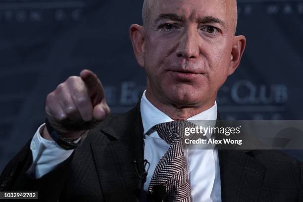 And founder of Amazon Jeff Bezos participates in a discussion during a Milestone Celebration dinner September 13, 2018 in Washington, DC. Economic...