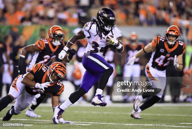 Alex Collins of the Baltimore Ravens carries the ball against the Cincinnati Bengals at Paul Brown Stadium on September 13, 2018 in Cincinnati, Ohio.