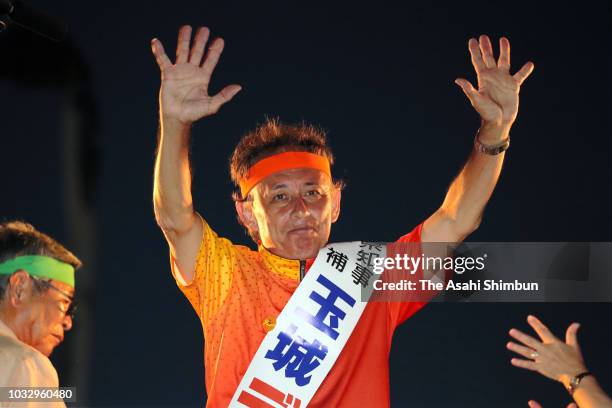 Opposition 'All Okinawa' movement backed candidate Denny Tamaki waves to his supporters during a street speech in front of the Okinawa Prefecture...