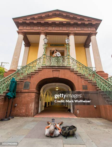 Charleston professional photographer Justin Falk, foreground, photographs newlyweds Kathryn and Anthony Palmisano on the steps of the Charleston City...