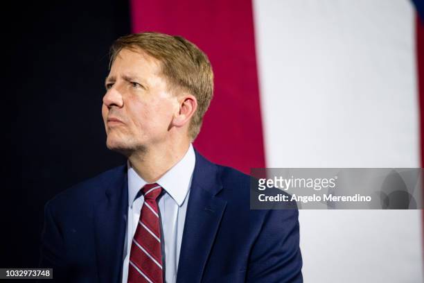 Ohio Democratic Gubernatorial candidate Richard Cordray listens while former president Barack Obama speaks during a campaign rally at CMSD East...