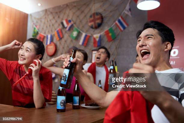the fans watching the game - china fans cheer stock pictures, royalty-free photos & images