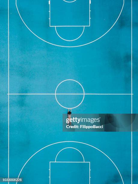 aerial view of a girl hanging in a basketball court - basket sport stock pictures, royalty-free photos & images