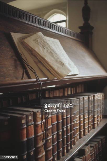 Books and old manuscripts are chained to lecterns in Trinity Hall Library, Cambridge University, circa 1975.