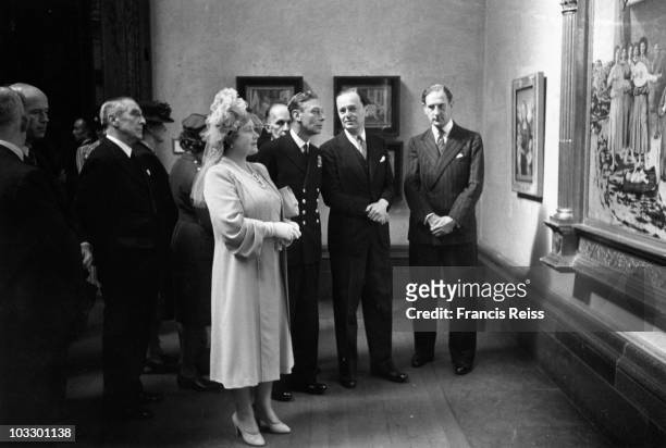 The Queen Mother views a painting as King George VI talks to British art historian Sir Kenneth Clark at the National Gallery, London, where they were...