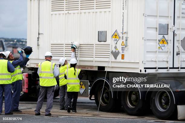 Worker controls the radioactivity level of a container with irradiated nuclear fuel from Australia discharged from the BBC Austria ship, on September...