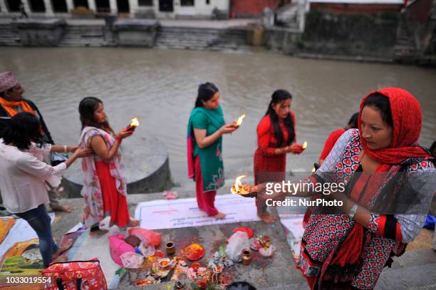 Nepalese devotees offering ritual prayer at the Bank of Bagmati River of Pashupatinath Temple during Rishi Panchami Festival celebrations at...