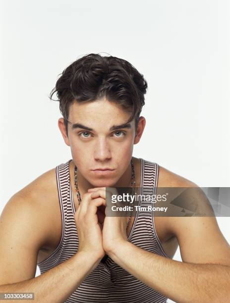 Singer Robbie Williams of English boy band Take That, circa 1992.