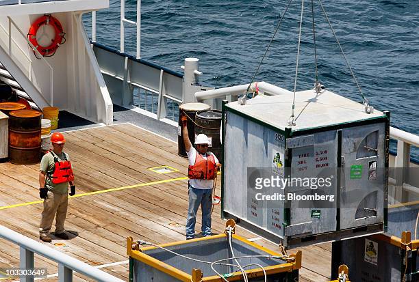 Supplies are lifted from the deck of the support vessel Janson R. Graham to the Transocean Ltd. Development Driller II rig, which is drilling a...