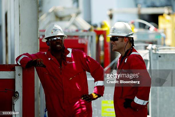 Transocean Ltd. Workers talk on board the Development Driller II rig, which is drilling a relief well at the BP Plc Macondo site in the Gulf of...