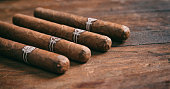 Cigars on wooden background, copy space