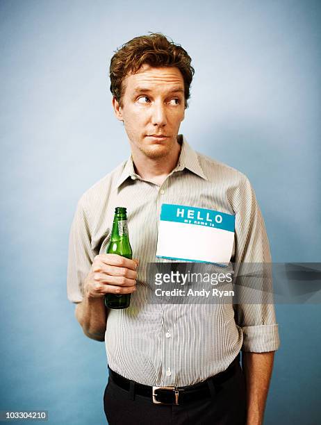 shy man holding beer at social function - reserved photos et images de collection