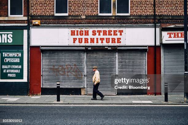 Pedestrian passes past a shuttered furniture retail shop in Wallsend, U.K., on Thursday, Sept. 6, 2018. The northeast of England illustrates the...