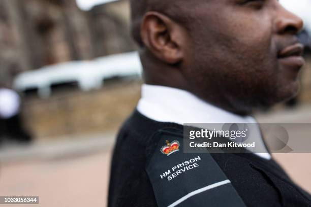 Prison staff at H.M.P Wandsworth stands as others gather outside after staging a 'walk-out' on September 14, 2018 in London, England. The Prison...