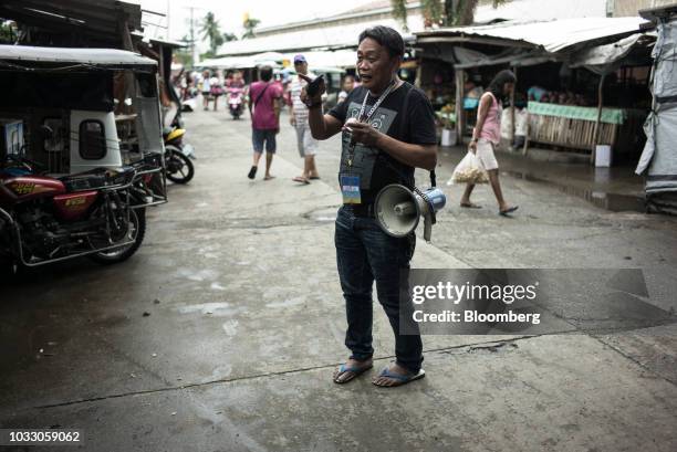 An official from the Mayor's office uses a megaphone to make announcements ahead of Typhoon Mangkhut's arrival in Tuguegarao, Cagayan province, the...