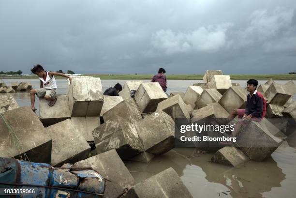 Boys sit on a breakwater while fishing along the Cagayan River ahead of Typhoon Mangkhut's arrival in Tuguegarao, Cagayan province, the Philippines,...