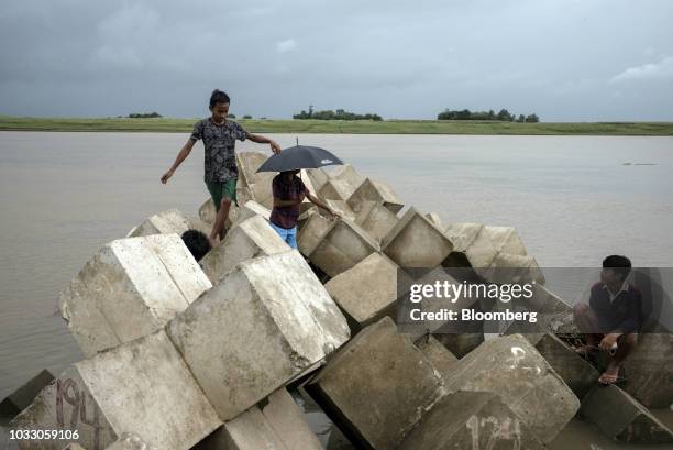 Boys stand on a breakwater while fishing along the Cagayan River ahead of Typhoon Mangkhut's arrival in Tuguegarao, Cagayan province, the...