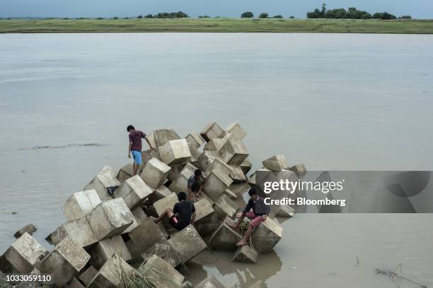 Boys sit on a breakwater while fishing along the Cagayan River ahead of Typhoon Mangkhut's arrival in Tuguegarao, Cagayan province, the Philippines,...