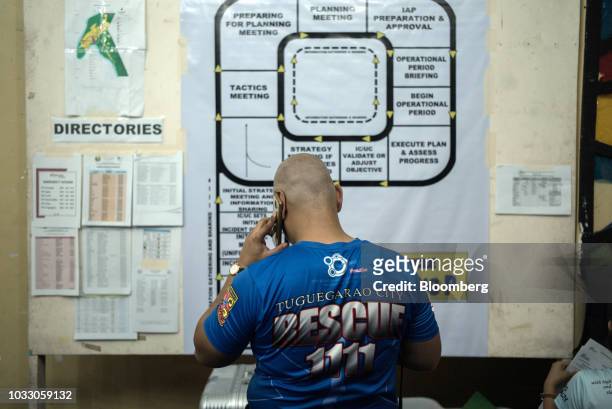 Man talks on a mobile phone at a makeshift disaster relief operations center ahead of Typhoon Mangkhut's arrival in Tuguegarao, Cagayan province, the...