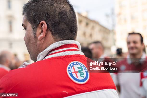 Workers wearing Ferrari uniforms line up to attend a memorial service for former Fiat Chrysler Automobiles NV chief executive officer Sergio...