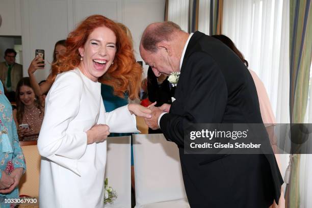 Bride Laura Kaefer and bridegroom Ralph Siegel exchanges rings during their civil wedding at the registry office Gruenwald on September 14, 2018 in...