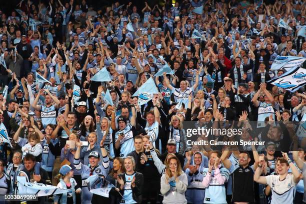 Sharks fans celebrate victory following the NRL Semi Final match between the Cronulla Sharks and the Penrith Panthers at Allianz Stadium on September...