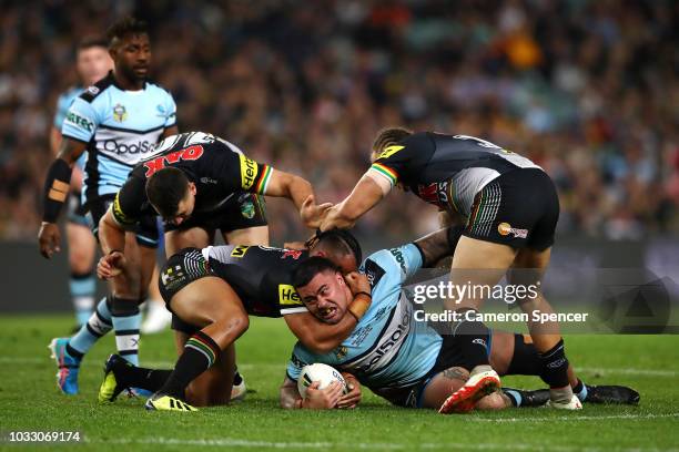 Andrew Fifita of the Sharks is tackled during the NRL Semi Final match between the Cronulla Sharks and the Penrith Panthers at Allianz Stadium on...