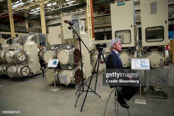 Joe Kaeser, chief executive officer of Siemens AG, speaks during a Bloomberg Television interview on the factory floor at the Siemens switchgear...