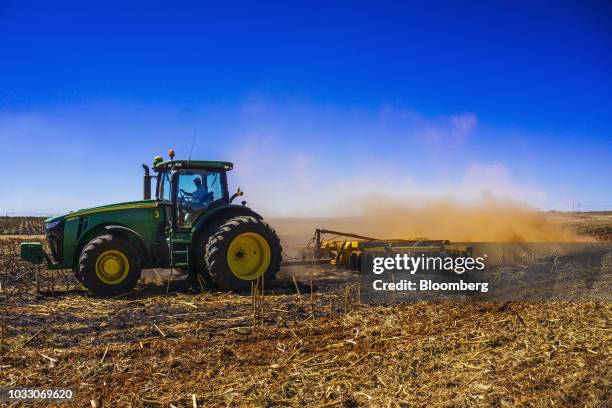 Tractor ploughs ground through a harvested corn field on the Ehlerskroon farm, outside Delmas in the Mpumalanga province, South Africa on Thursday,...