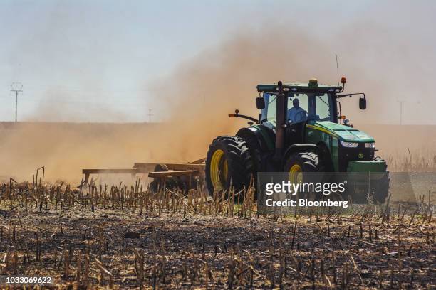 Tractor ploughs ground through a harvested corn field on the Ehlerskroon farm, outside Delmas in the Mpumalanga province, South Africa on Thursday,...