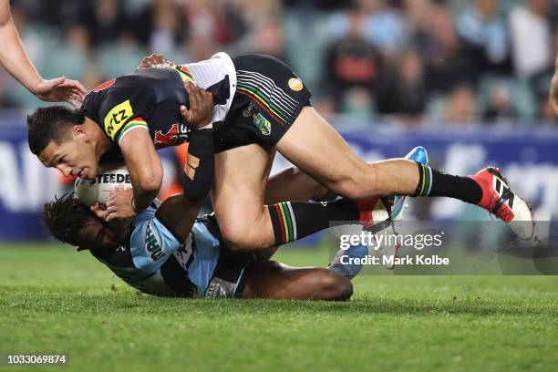 James Segeyaro of the Sharks tackles Dallin Watene Zelezniak of the Panthers during the NRL Semi Final match between the Cronulla Sharks and the...