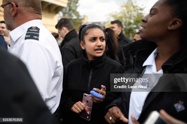 Prison staff and supporters listen as they are told to return to work at 1pm, outside HM Prison Bedford at the end of an unofficial protest on...