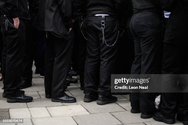 Utility belts and keychains are seen on uniformed officers as prison staff gather outside HM Prison Bedford during an unofficial protest on September...