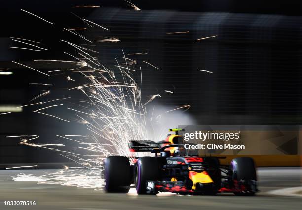 Sparks fly behind Max Verstappen of the Netherlands driving the Aston Martin Red Bull Racing RB14 TAG Heuer on track during practice for the Formula...