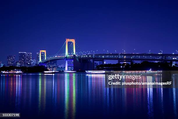 night time view of the illuminated rainbow bridge. tokyo prefecture, japan - plusphoto stock pictures, royalty-free photos & images