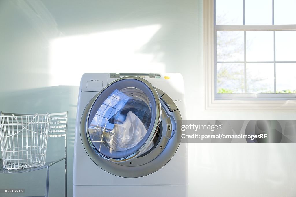 A front-loading washing machine filled with clothes