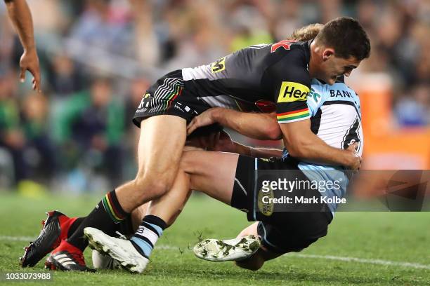 Nathan Cleary of the Panthers tackles Matt Moylan of the Sharks during the NRL Semi Final match between the Cronulla Sharks and the Penrith Panthers...