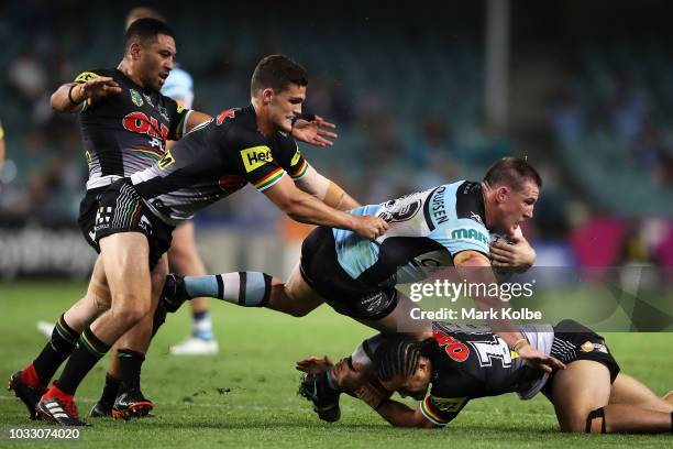 Paul Gallen of the Sharks is tackled during the NRL Semi Final match between the Cronulla Sharks and the Penrith Panthers at Allianz Stadium on...