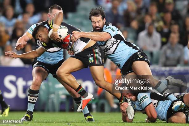 Tyrone Peachey of the Panthers is tackled by Paul Gallen and Aaron Woods of the Sharks during the NRL Semi Final match between the Cronulla Sharks...