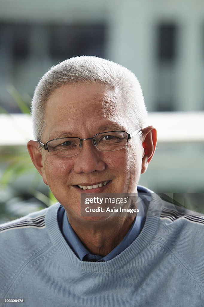 Head shot of older man with grey hair