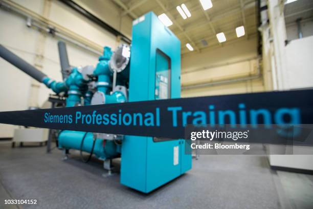 An insulated gas switchgear mechanism sits on display in the training center inside Siemens AG electronic power unit factory in Berlin, Germany, on...