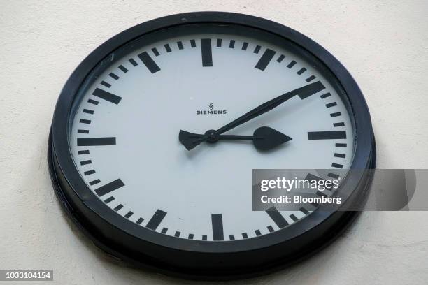 Siemens AG branded clock sits on a wall in the training center inside the company's switchgear electronic power unit factory in Berlin, Germany, on...