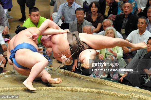 Shodai throws Mongolian yokozuna Hakuho to win on day six of the Grand Sumo Autumn Tournament at Ryogoku Kokugikan on September 14, 2018 in Tokyo,...