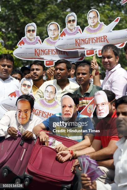 Members of Indian Youth Congress protest against Finance Minister Arun Jaitley and businessman Vijay Mallya at Udyog Bhawan, on September 14, 2018 in...