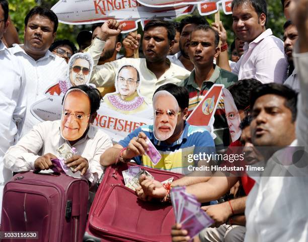 Members of Indian Youth Congress protest against Finance Minister Arun Jaitley and businessman Vijay Mallya at Udyog Bhawan, on September 14, 2018 in...