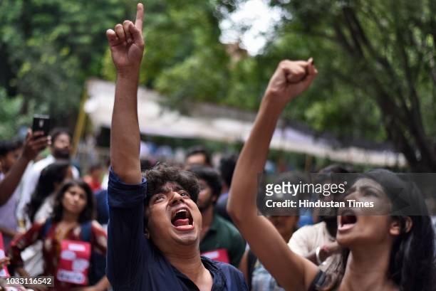 Members of the different Students' Unions shout slogans in support of their candidates during Jawaharlal Nehru University Students Union Elections,...