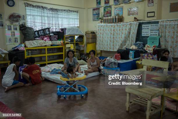 Families gather the temporary evacuation center at Balzain East Elementary School ahead of Typhoon Mangkhut's arrival in Tuguegarao, Cagayan...