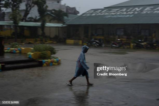 Boy wears a rain coat in heavy rainfall outside the temporary evacuation center at Balzain East Elementary School ahead of Typhoon Mangkhut's arrival...